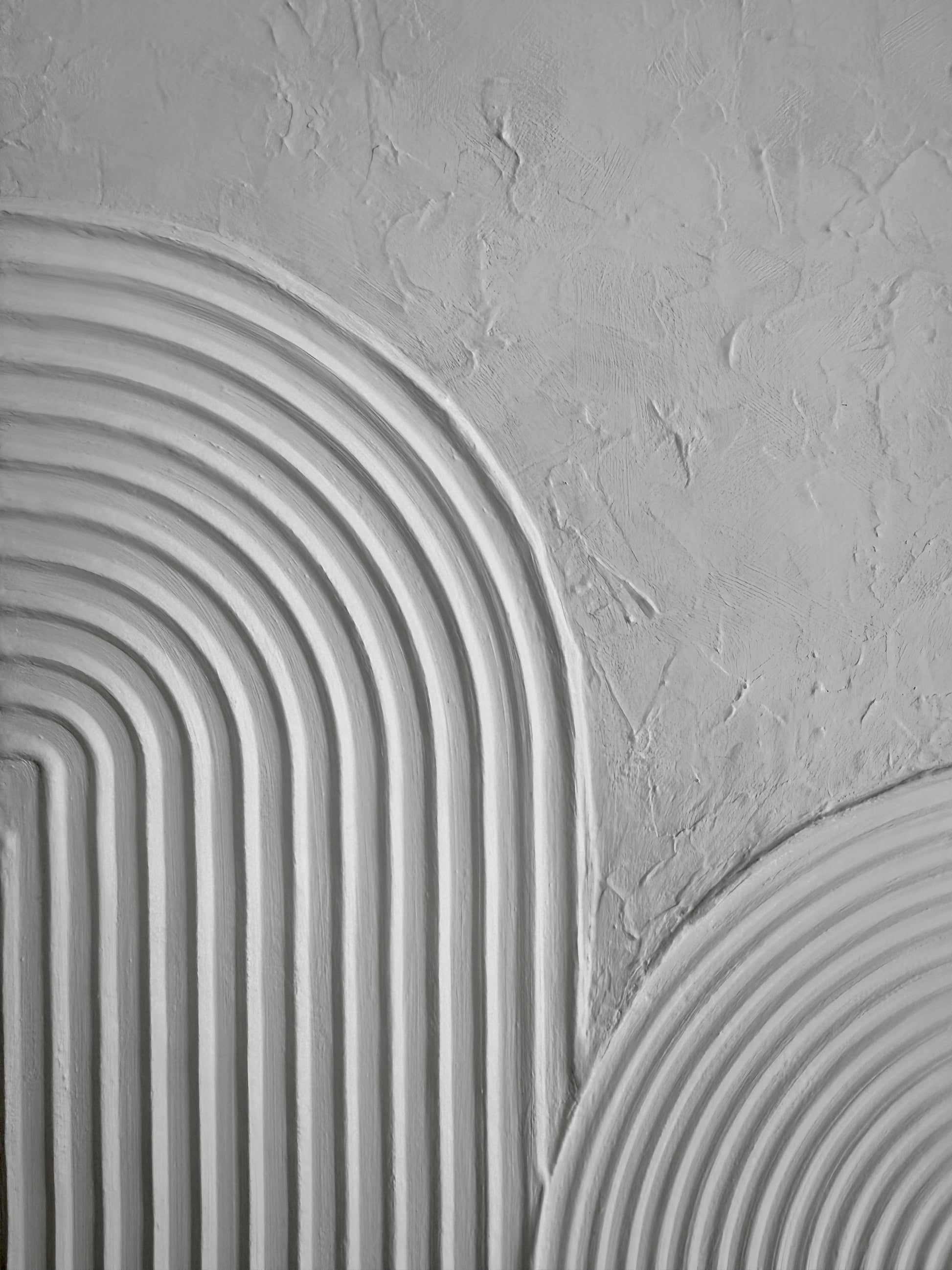 Close-up of textured gray wall with circular patterns