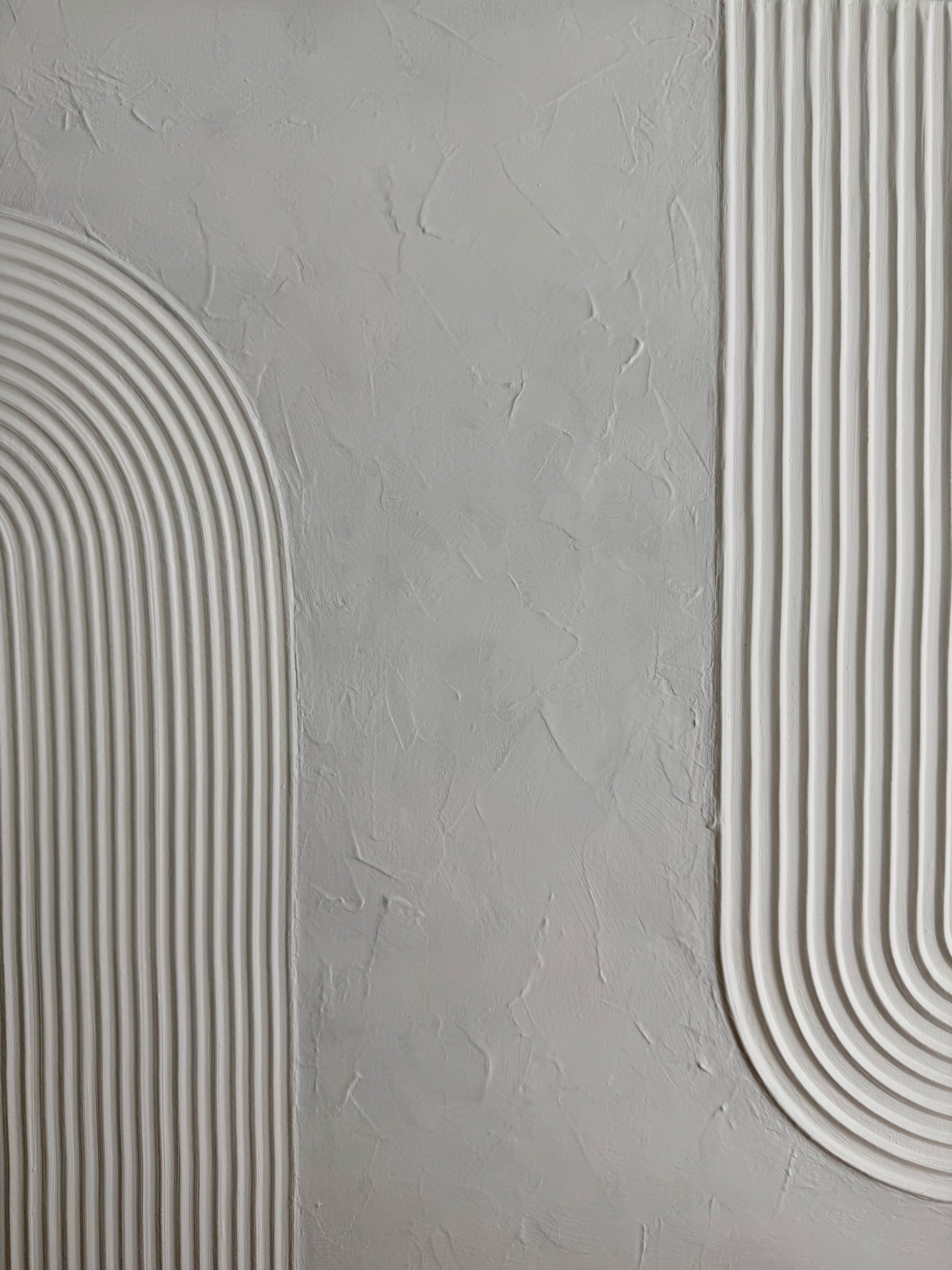 Gray textured wall with white curved lines