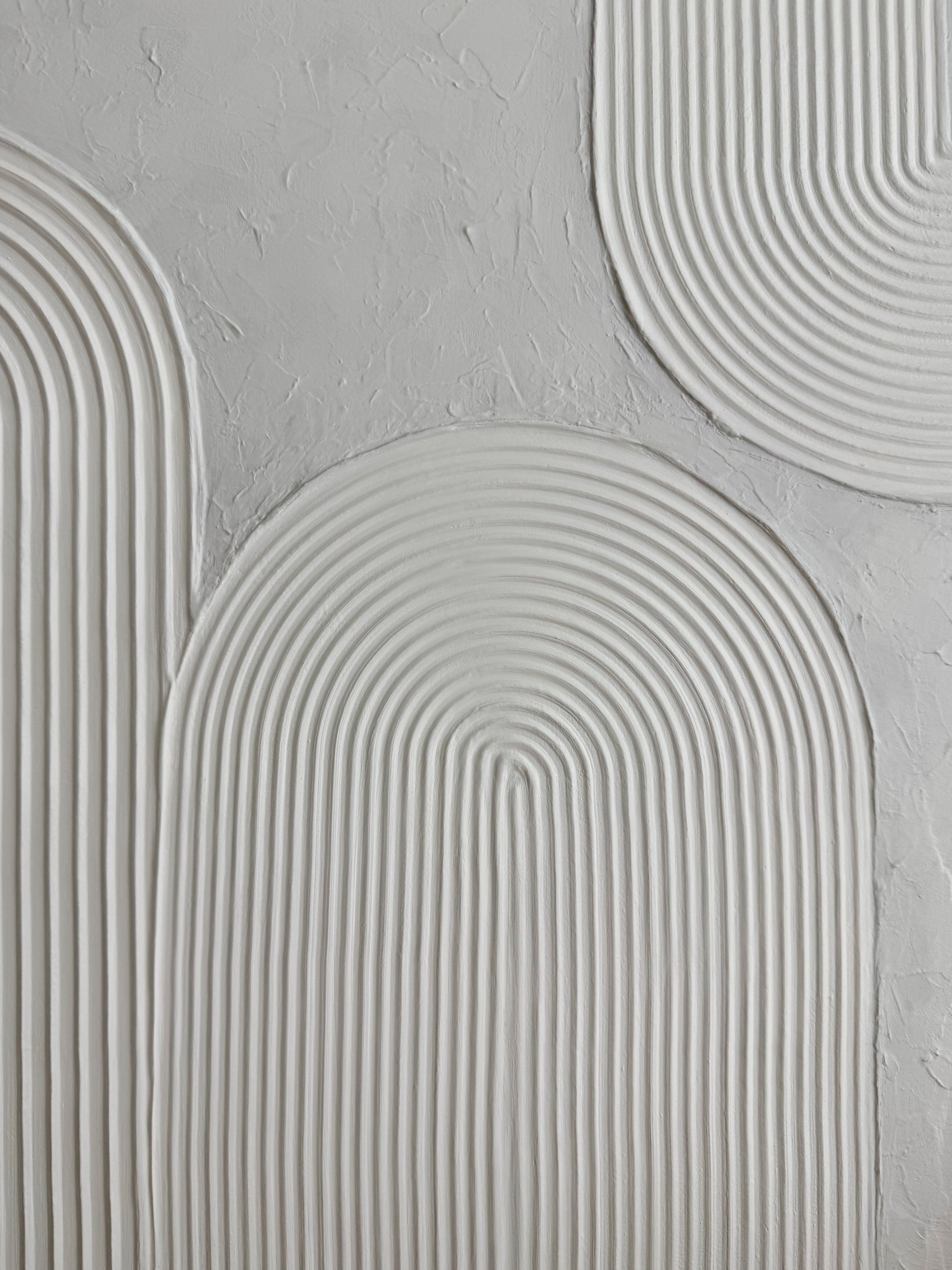 Close-up of textured gray wall with curved patterns