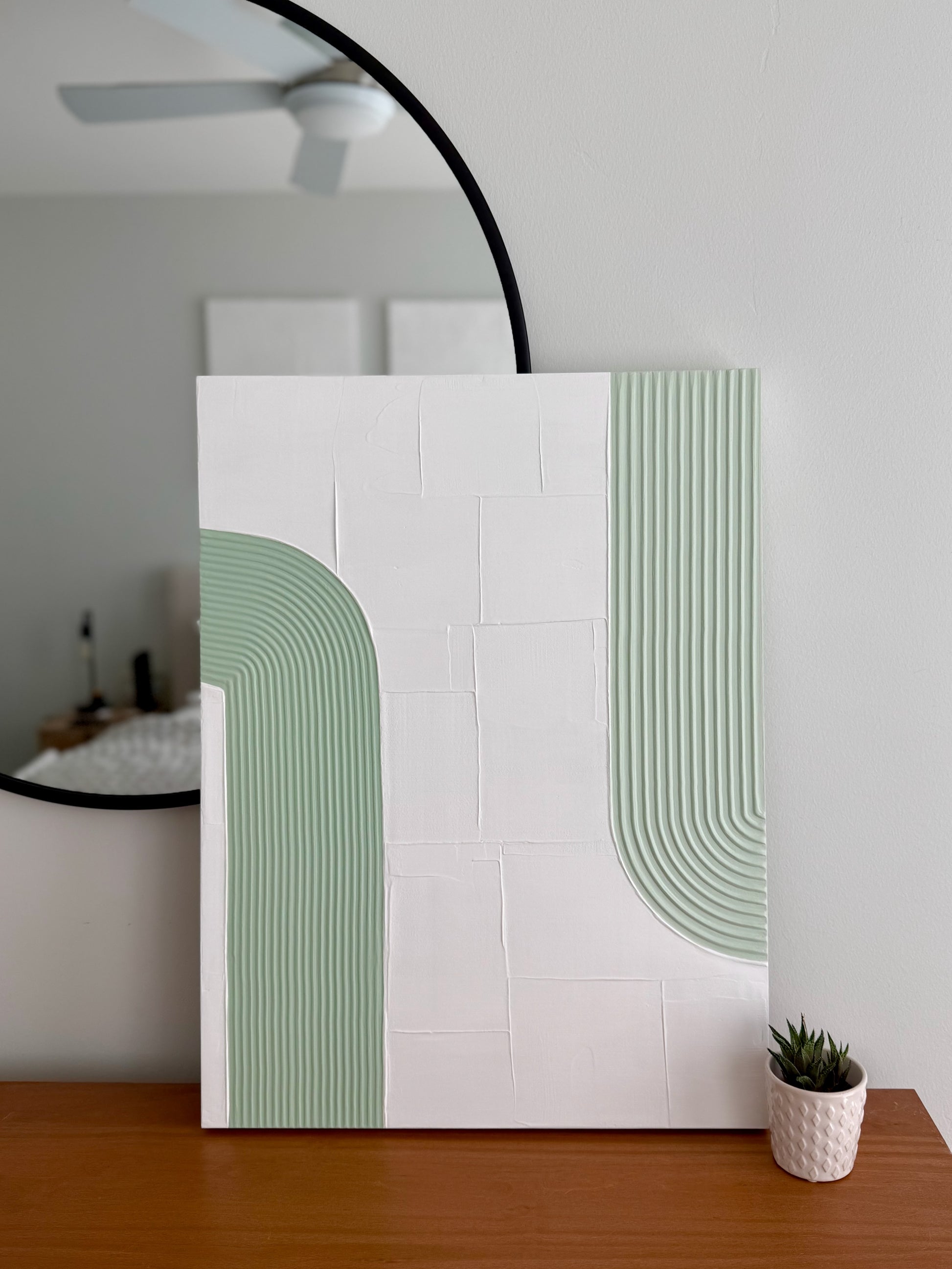 textured artwork with green and white pattern in a room setting