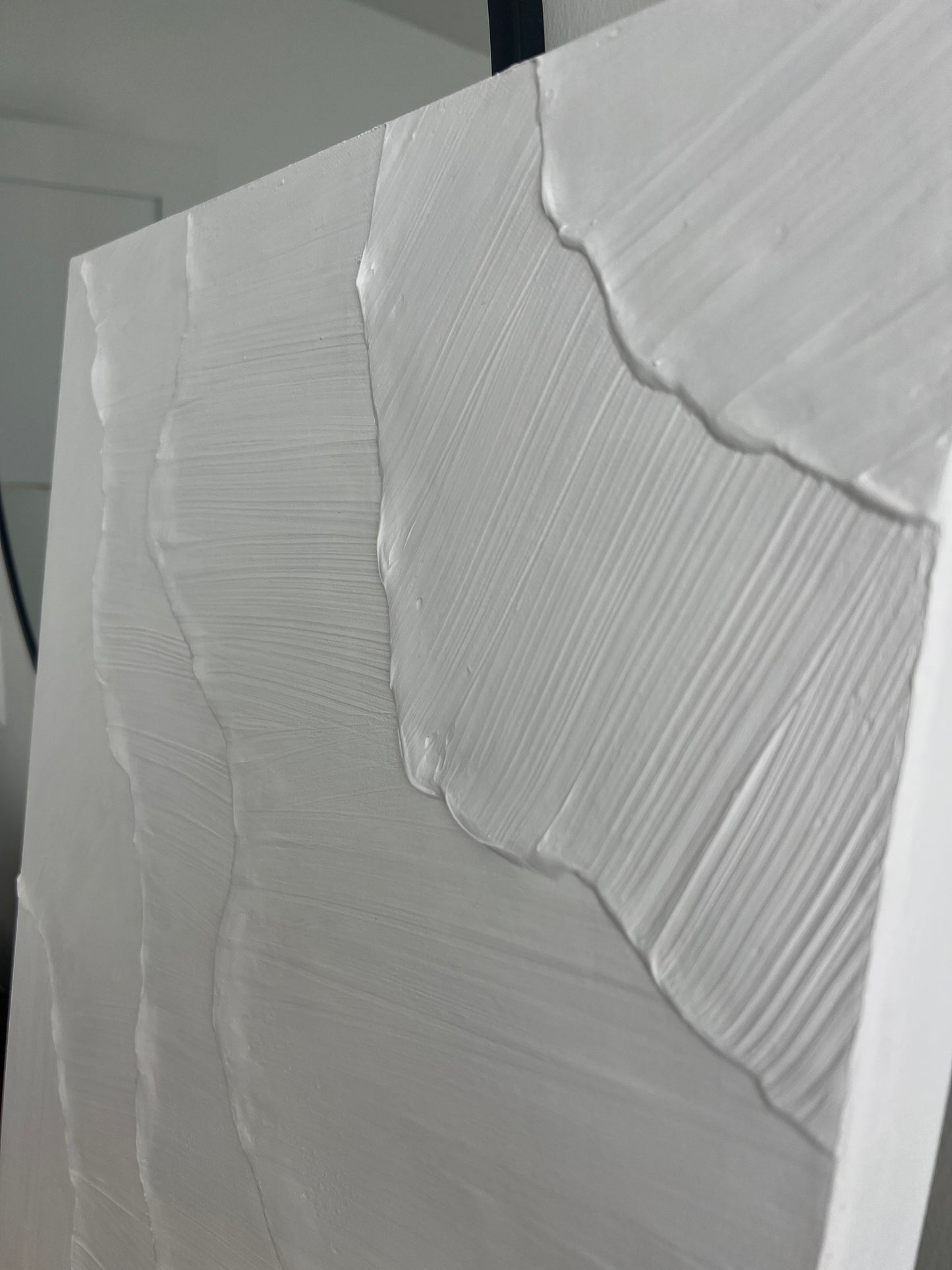 Close-up of a textured white surface with wavy patterns