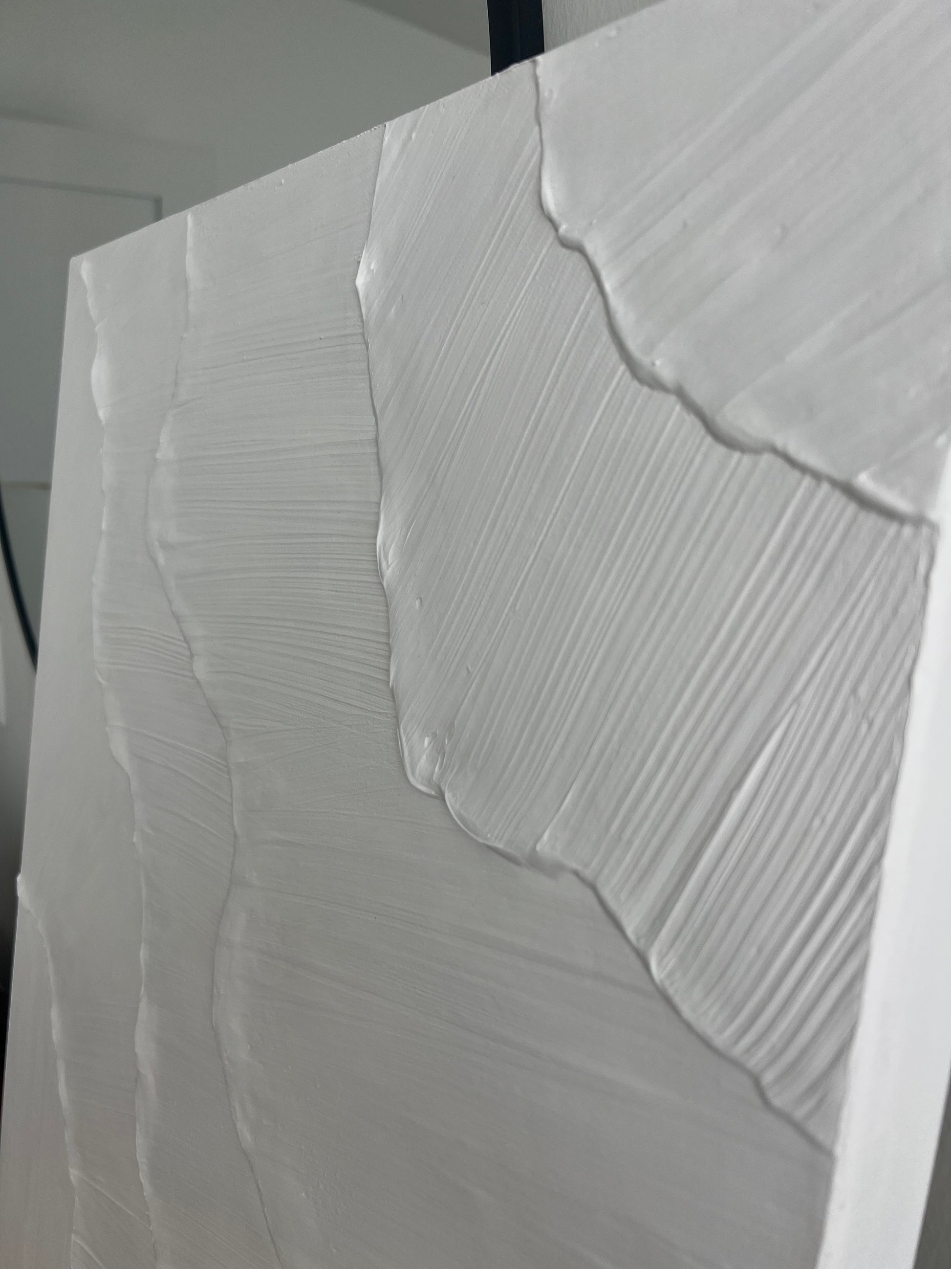 Close-up of a textured white surface with wavy patterns