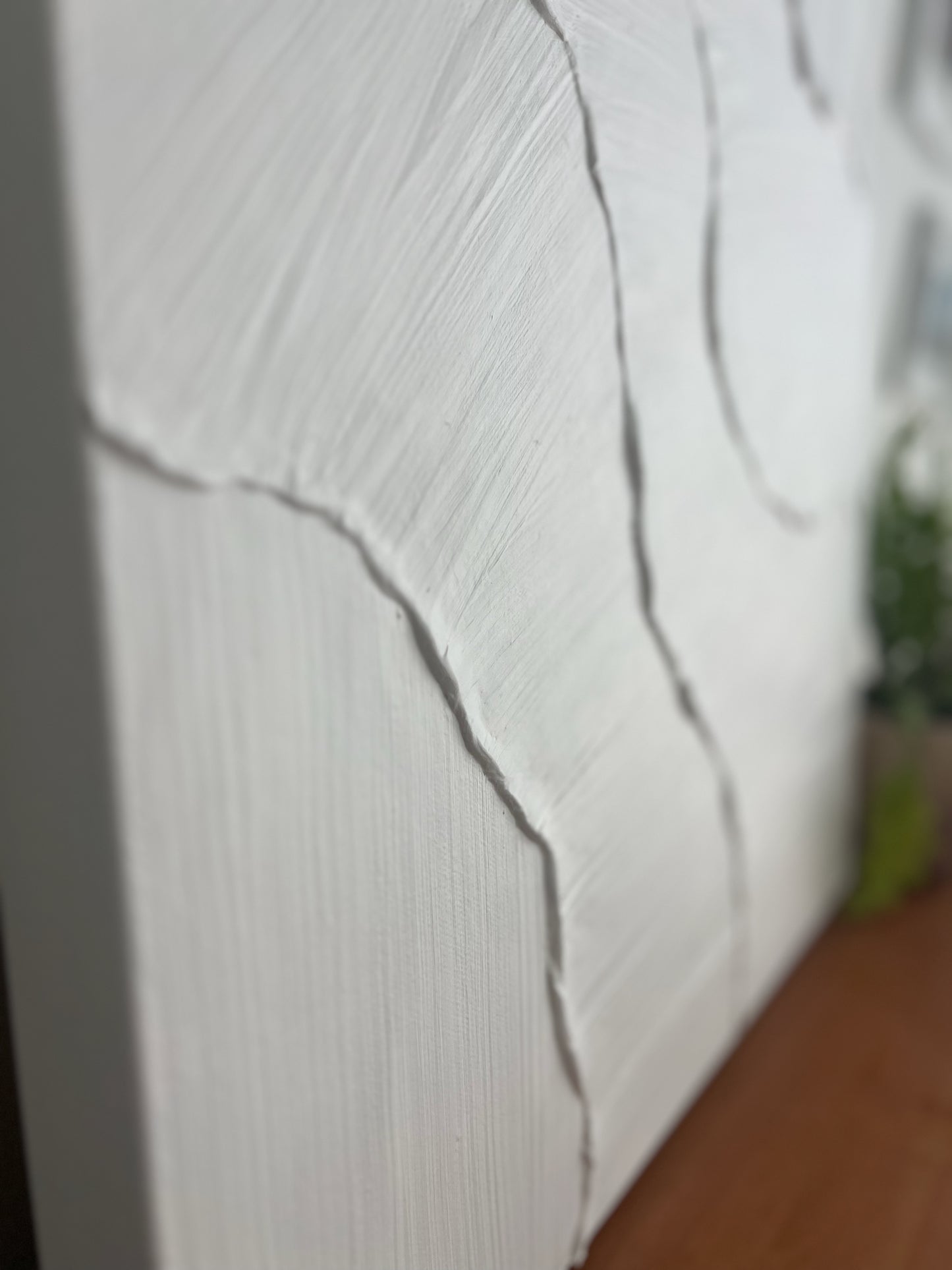Close-up of a textured white surface with a blurred background