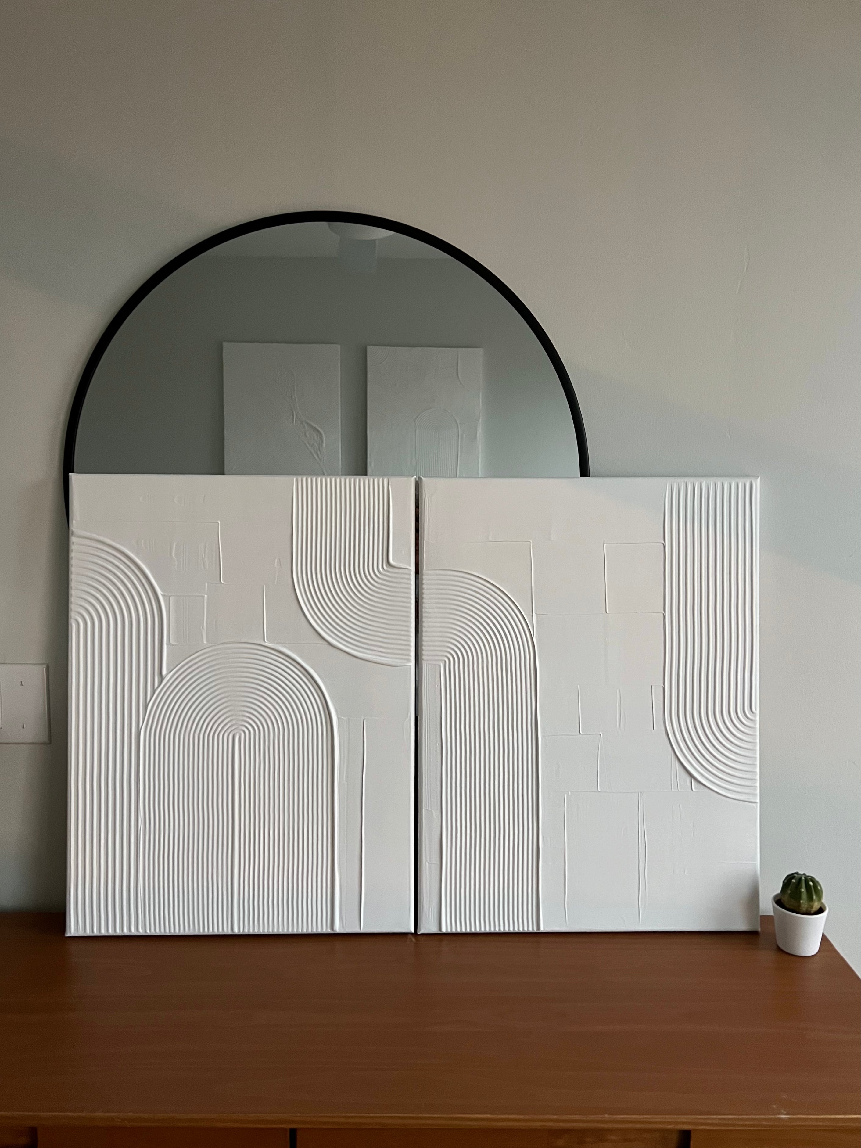 set of 2 canvas white textured artwork on top of a dresser